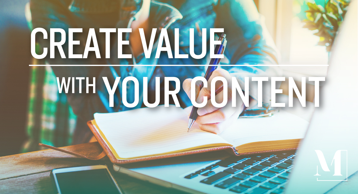 An individual writing in a journal with her laptop open. Create value with your content.