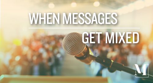 The microphone, podium and audience from a speaker's point of view. Text: when messages get mixed.