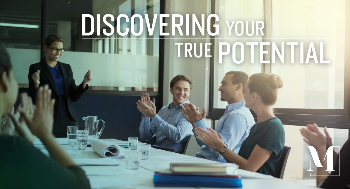 Female leader speaking to her team at a conference table.