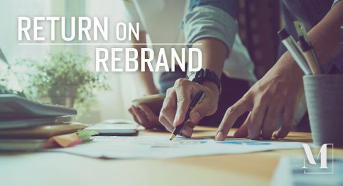 Two designers reviewing content and mockups with text: "Return on Rebrand."