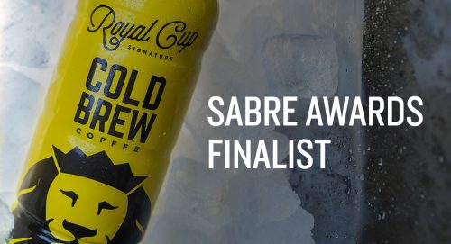 A bottle of cold brew on ice with text: "Sabre Awards Finalist"